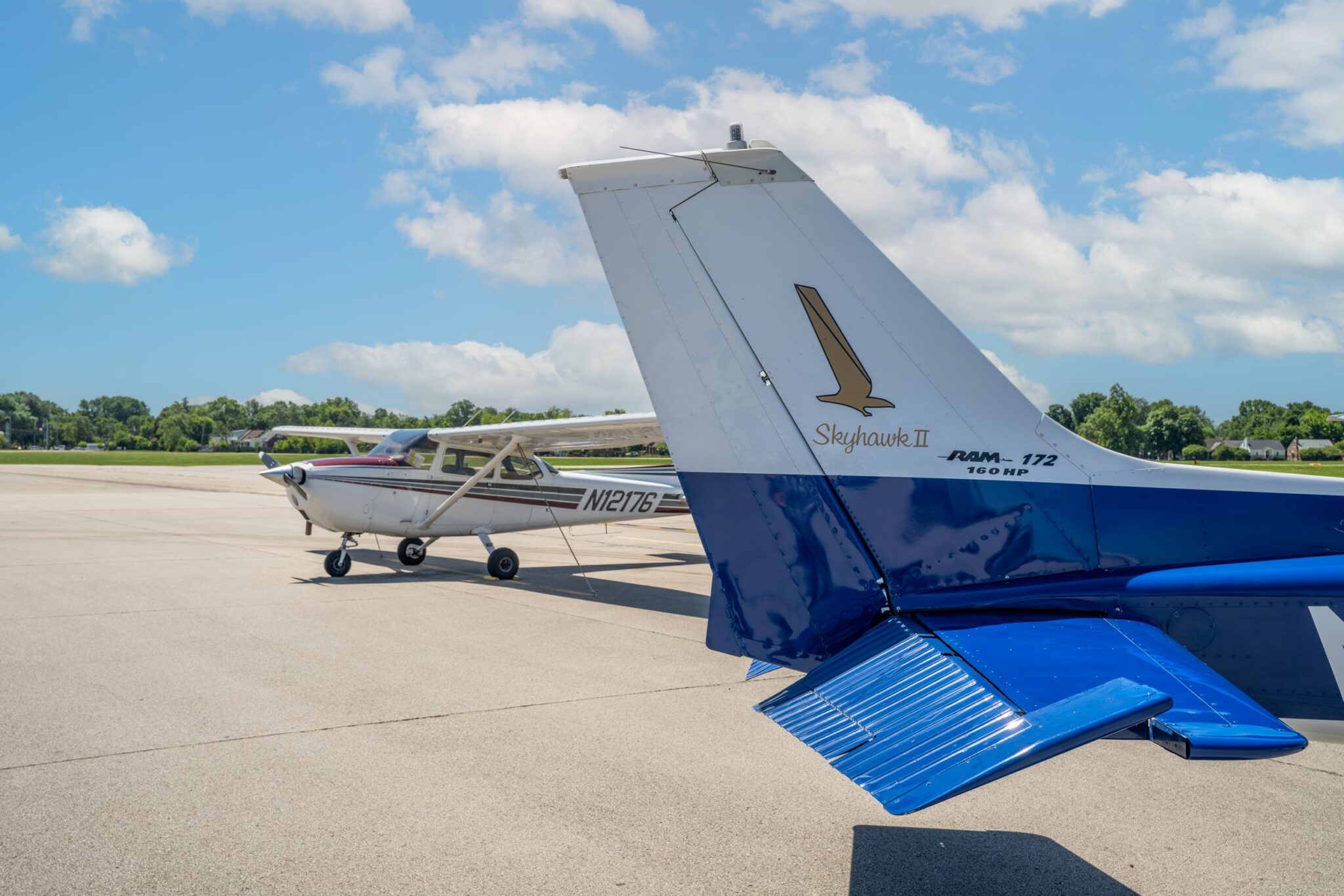 Cessna Skyhawk II tail with aircraft lineup on the ramp at Bowman Field
