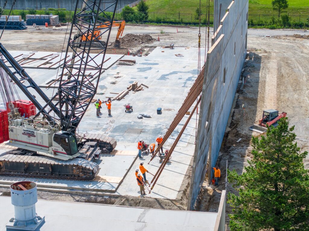 Crawler crane and crew setting structure on a Kentucky jobsite, photographed from the air
