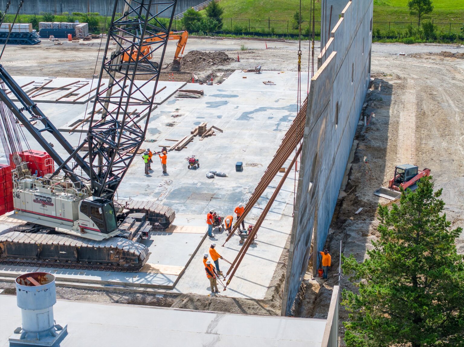 Crawler crane and crew setting structure on a Kentucky jobsite, photographed from the air