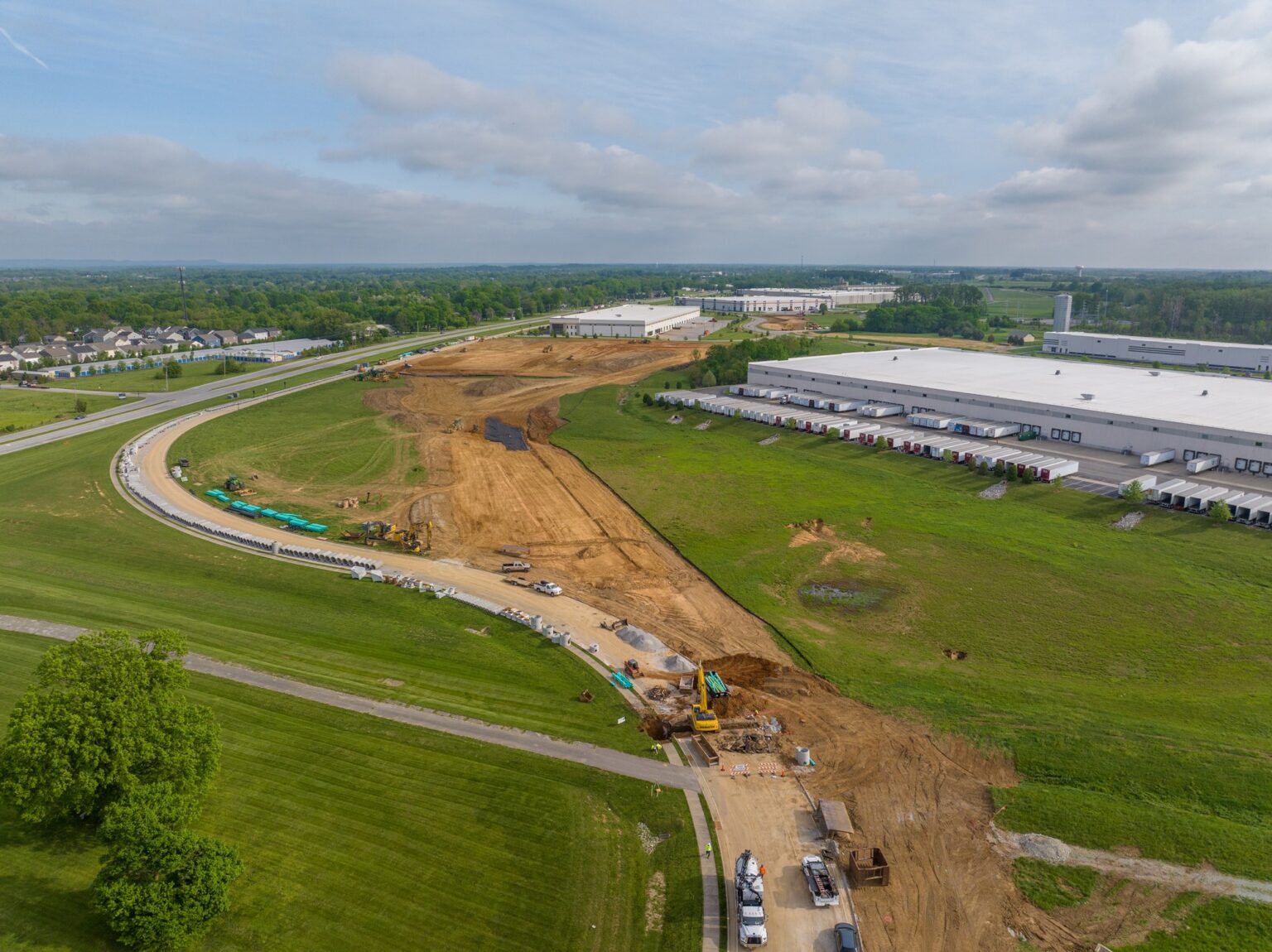Aerial photograph of an active Indiana construction site showing crews, equipment, and the building structure