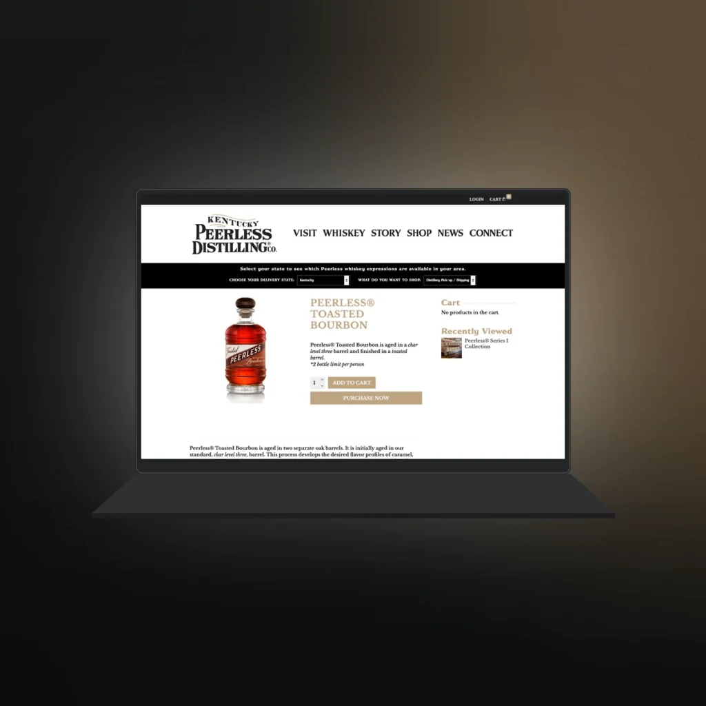 Laptop showing a Shop Peerless bourbon product page with add to cart, built by Shaun Wilson Designs