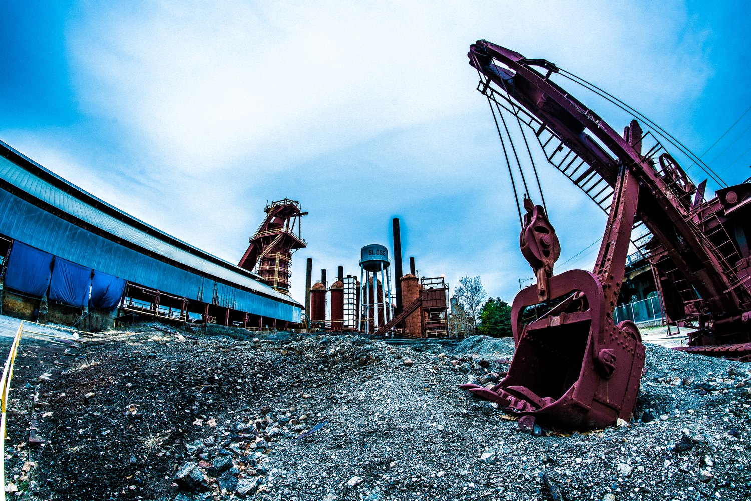 Heavy industrial equipment photographed against a dramatic sky by Shaun Wilson