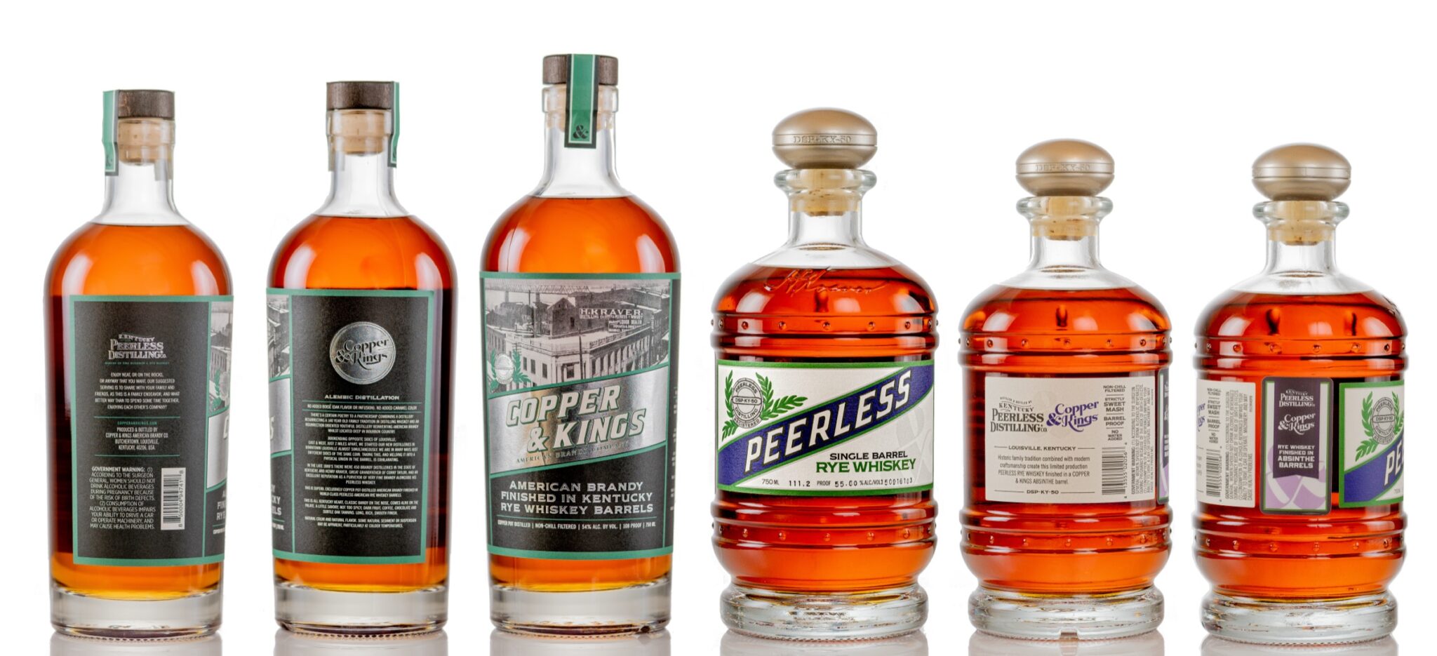 Studio product photography lineup of Kentucky Peerless and Copper and Kings bottles