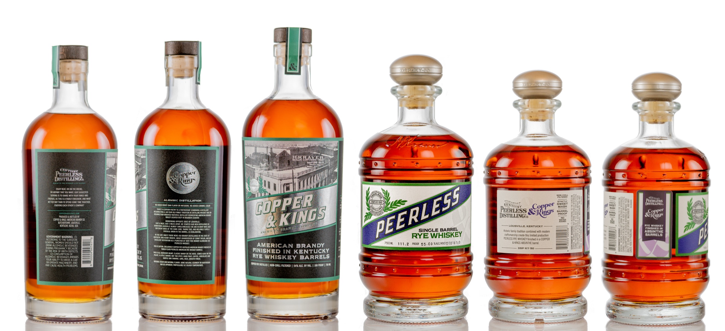 Studio product photography lineup of Kentucky Peerless and Copper and Kings bottles