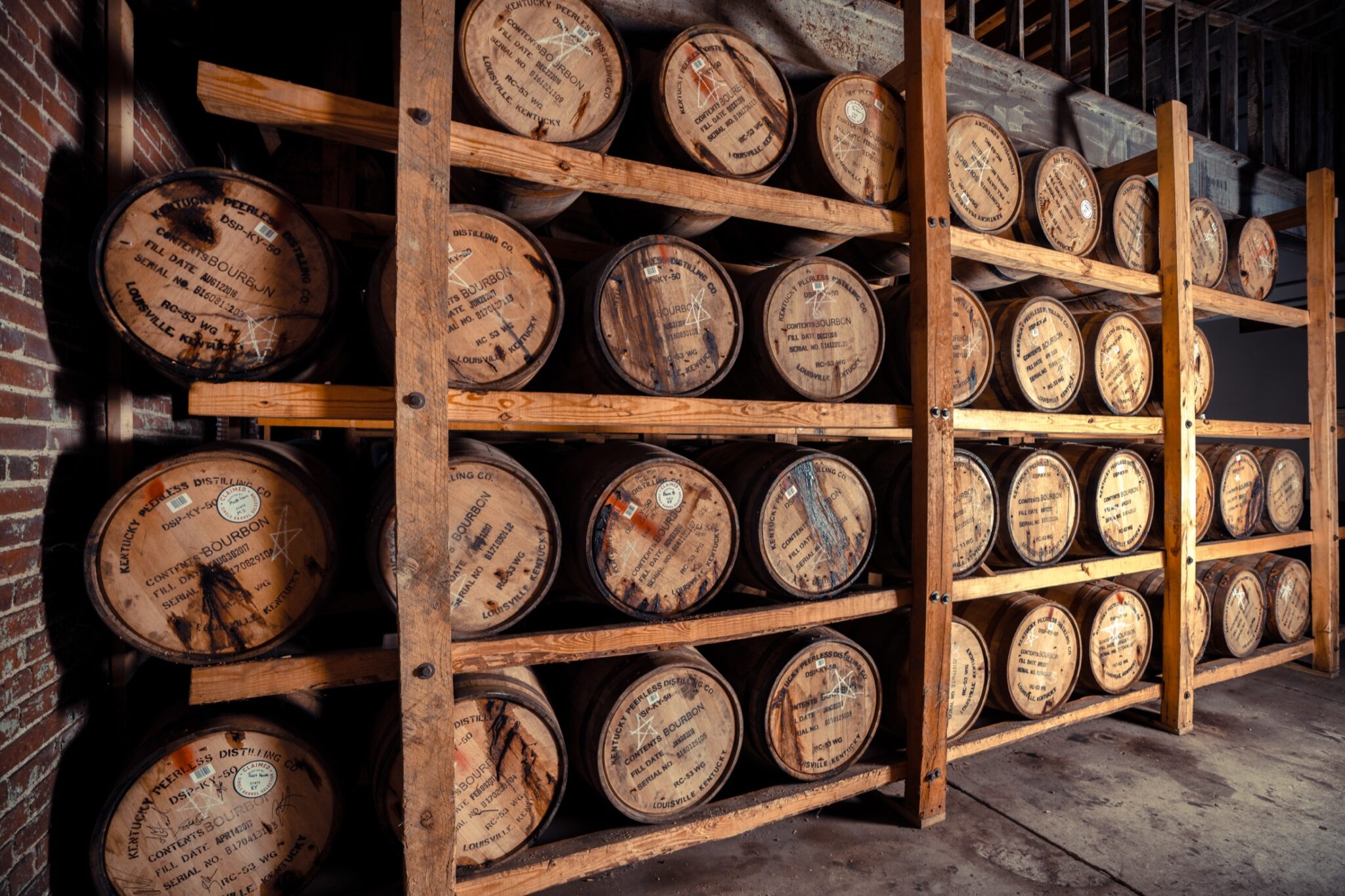 Bourbon barrels aging on wooden ricks at a Kentucky distillery