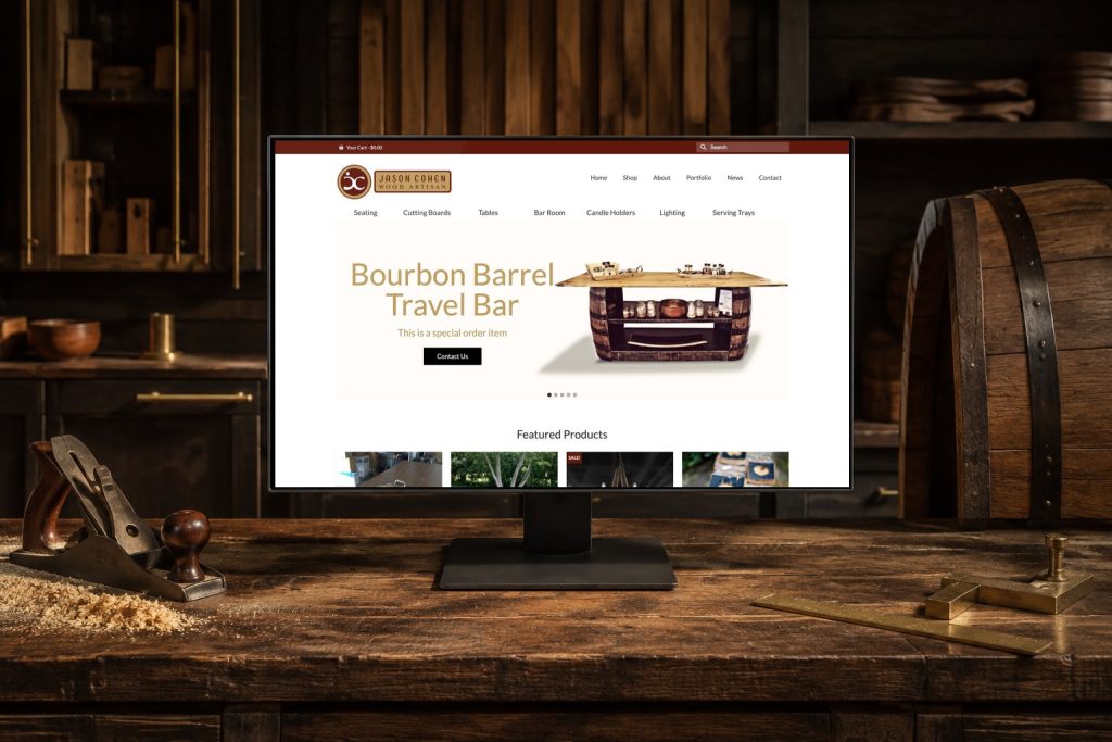 Bourbon Barrel Artisan website displayed in a refined cooperage and furniture workshop.