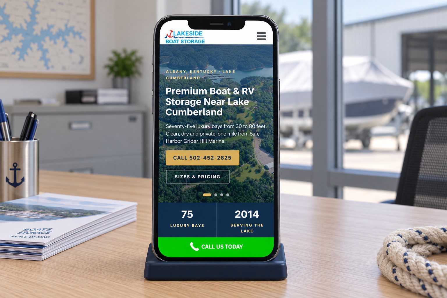 The Lakeside Boat Storage homepage on a phone with its call button, a presentation scene built from the real site.