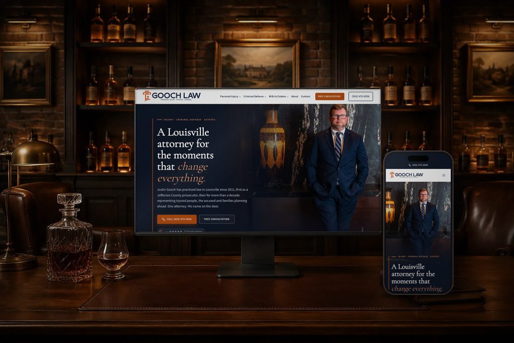 Gooch Law website on a desktop monitor and a phone in a wood-panelled law library, by Shaun Wilson Designs