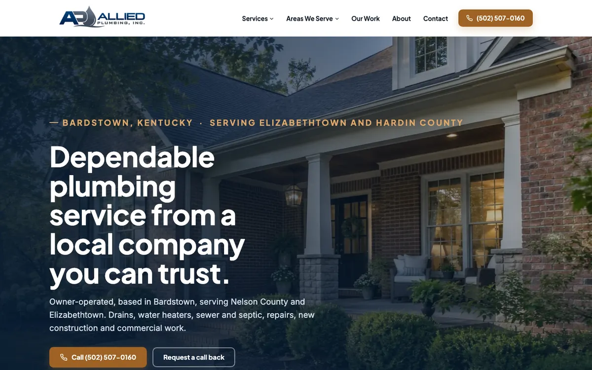 The Allied Plumbing website on a desk monitor beside a window over Louisville
